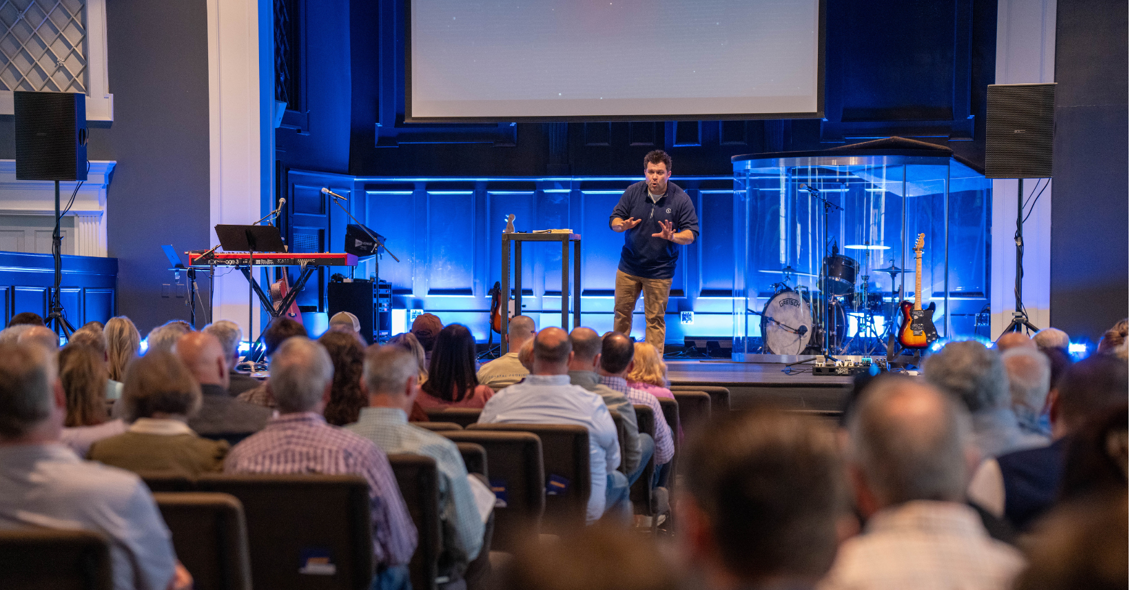 Dustin Dozier speaking on stage